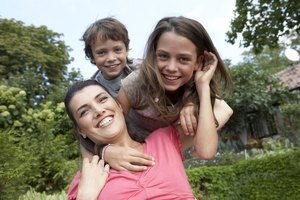 mother, daughter and son in garden