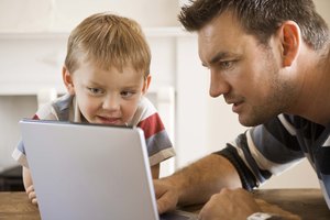 Father and son on laptop computer
