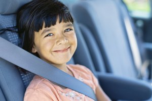 portrait of a girl sitting on the back seat of a car