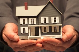 Man holding a miniature house