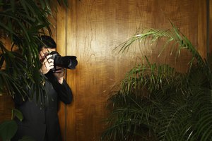 Man taking photograph in shadowy building interior