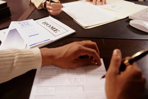 Man and woman signing documents at desk in office, close-up of hands, mid section