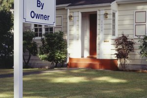 House with For Sale sign on front lawn