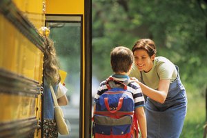 Mother sending son off to school at bus stop