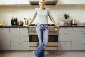 Young woman standing in kitchen, portrait