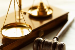 Close-up of weights balancing scales of justice with gavel beside it