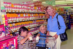 Mom and kids shopping in grocery store