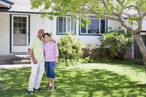 Portrait of smiling couple near house