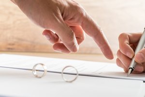 Male hand pointing to a divorce paper