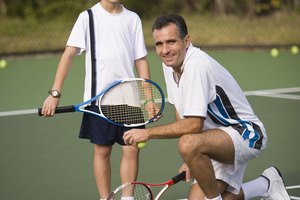 Father and son at tennis court
