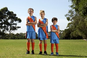 Portrait of three young football players