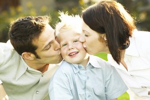 Parents kissing son