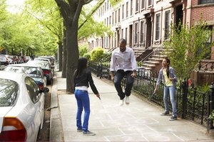 Father and daughters playing jump-rope