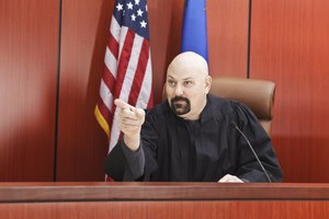 Male Judge Pointing While Seated in Courtroom