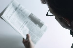 High angle view of woman reading newspaper