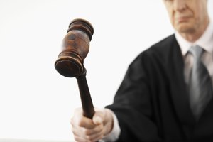 Barrister using gavel, studio shot