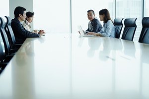 Four business people meeting in conference room