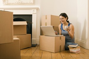 Woman with coffee and laptop in new home