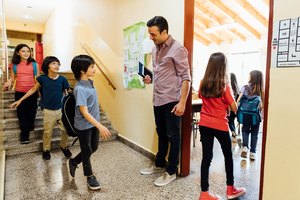 Teacher Welcoming Students to Class