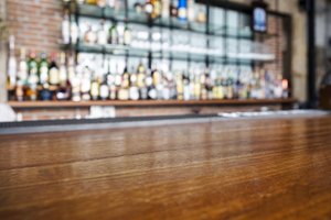 Top wooden table with Bar Blurred Background