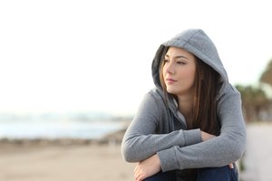 Longing pensive teenager looking away