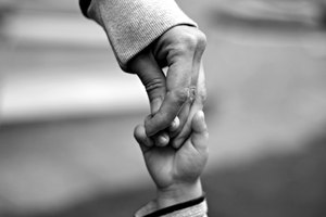 Close-Up Of The Hands Of A Mother And Her Child