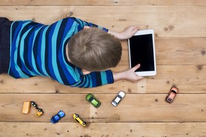 kid on floor with tablet pc