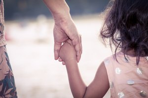 child cute little girl and mother holding hand together