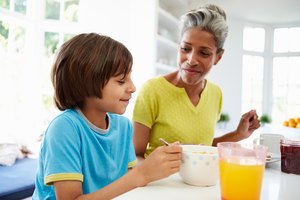 Grandmother and grandson enjoying breakfast together