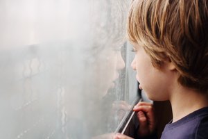 Cute boy looking through the window