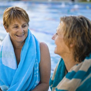 Two woman talking at pool