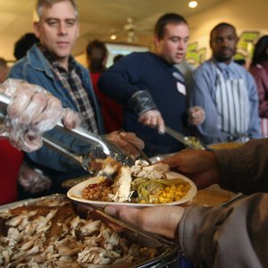 Volunteers feed the homeless at Thanksgiving.