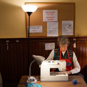 A woman sewing at a machine in a ministry.