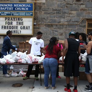 A church distributing bags of food during a food drive.