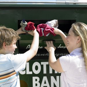 Mother and son donating clothing.