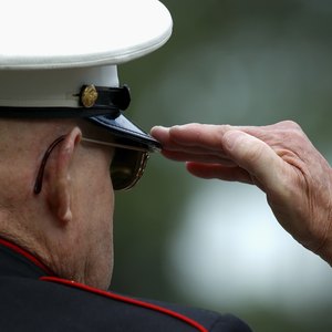 A veteran is saluting.