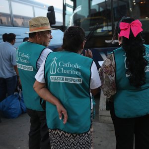 Three representatives from Catholic Charities