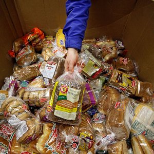 A collection of bread in a large cardboard box