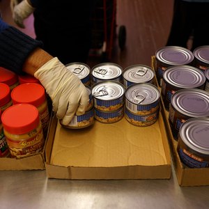 Volunteers stack items at a food pantry.