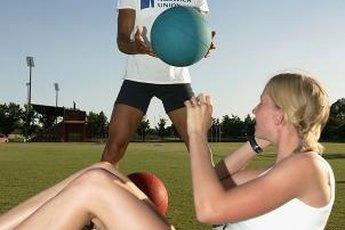 Athletes use a medicine ball to train.