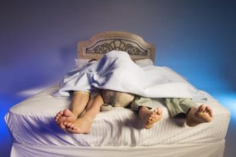 Give her a bed of her own in a nearby night stand so everyone sleeps better.