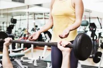 Use a spotter to reduce risk of weightlifting injuries.