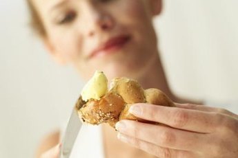 A dollop of butter adds about 30 milligrams of cholesterol to your dinner roll.