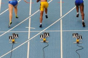 Female sprinters burst out of the blocks and enter the drive phase.