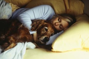 Cuddling with your dog can help relax you for sleep.