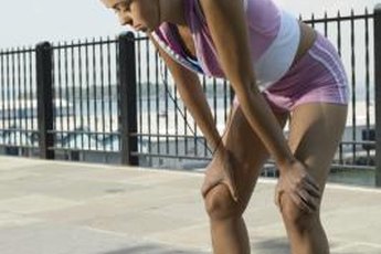 Stop your run and stretch out sore hamstrings.