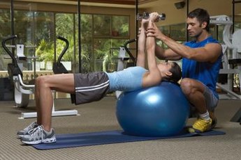 Beginners can seek a trainer's guidance for performing dumbbell presses.