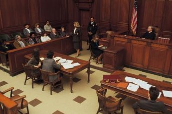 Criminal defense attorneys defend clients in a criminal trial.