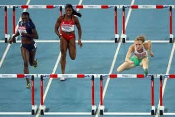 Sally Pearson of Australia throws her lead leg over the hurdle on her way to London Olympic gold.