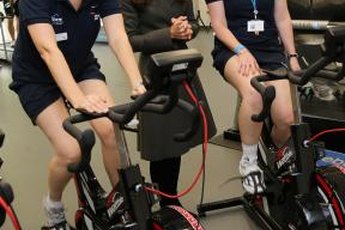 Prince William's wife Kate greets female soccer players training on spin bikes in England.